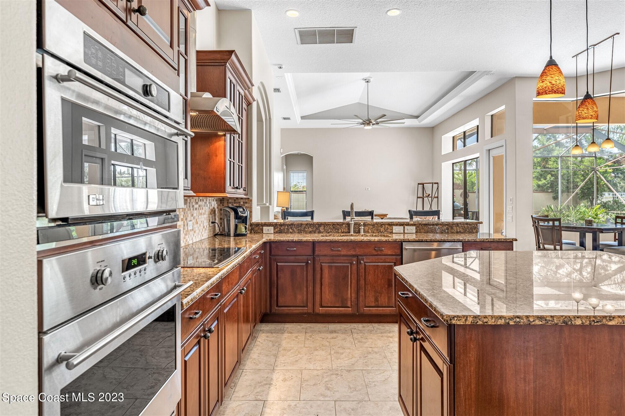 3550 Thurloe Drive Rockledge, FL 32955 - Photo 15 of 44 a kitchen with stainless steel appliances granite countertop a sink and cabinets
