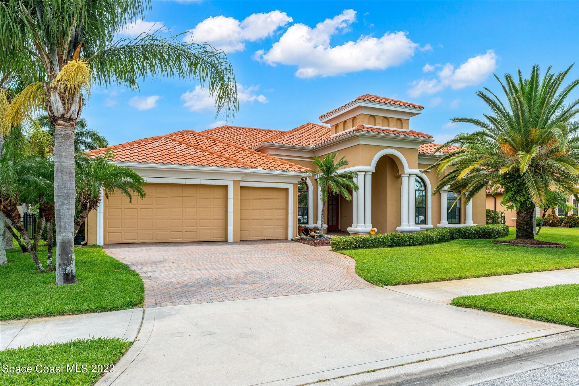 3550 Thurloe Drive Rockledge, FL 32955 - Photo 2 of 44 a front view of a house with a garden and trees