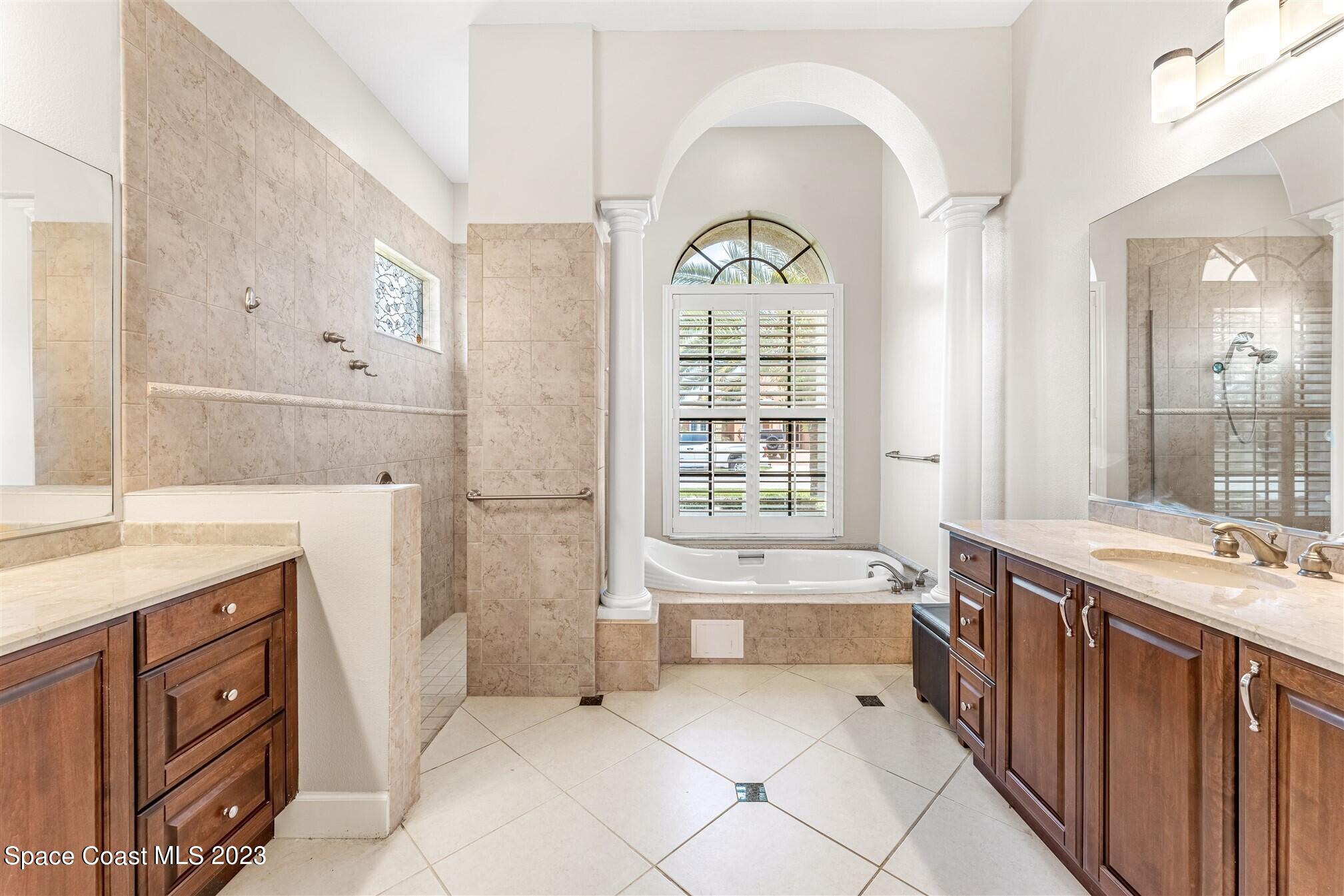 3550 Thurloe Drive Rockledge, FL 32955 - Photo 23 of 44 a spacious bathroom with a tub sink and mirror