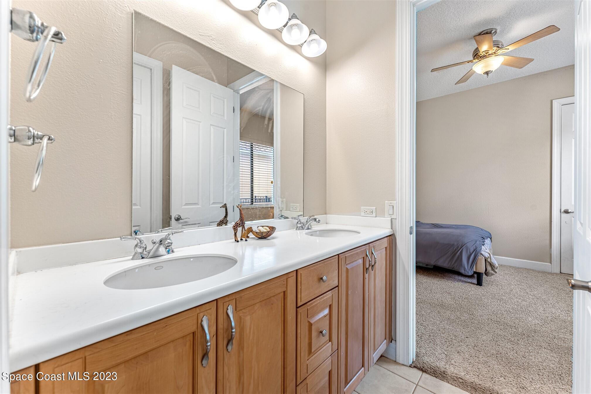 3550 Thurloe Drive Rockledge, FL 32955 - Photo 27 of 44 a en suite bathroom with a granite countertop sink and a mirror