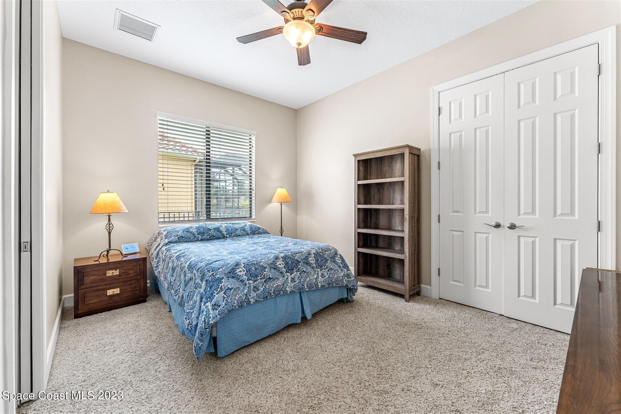 3550 Thurloe Drive Rockledge, FL 32955 - Photo 28 of 44 a bedroom with a bed and a chandelier