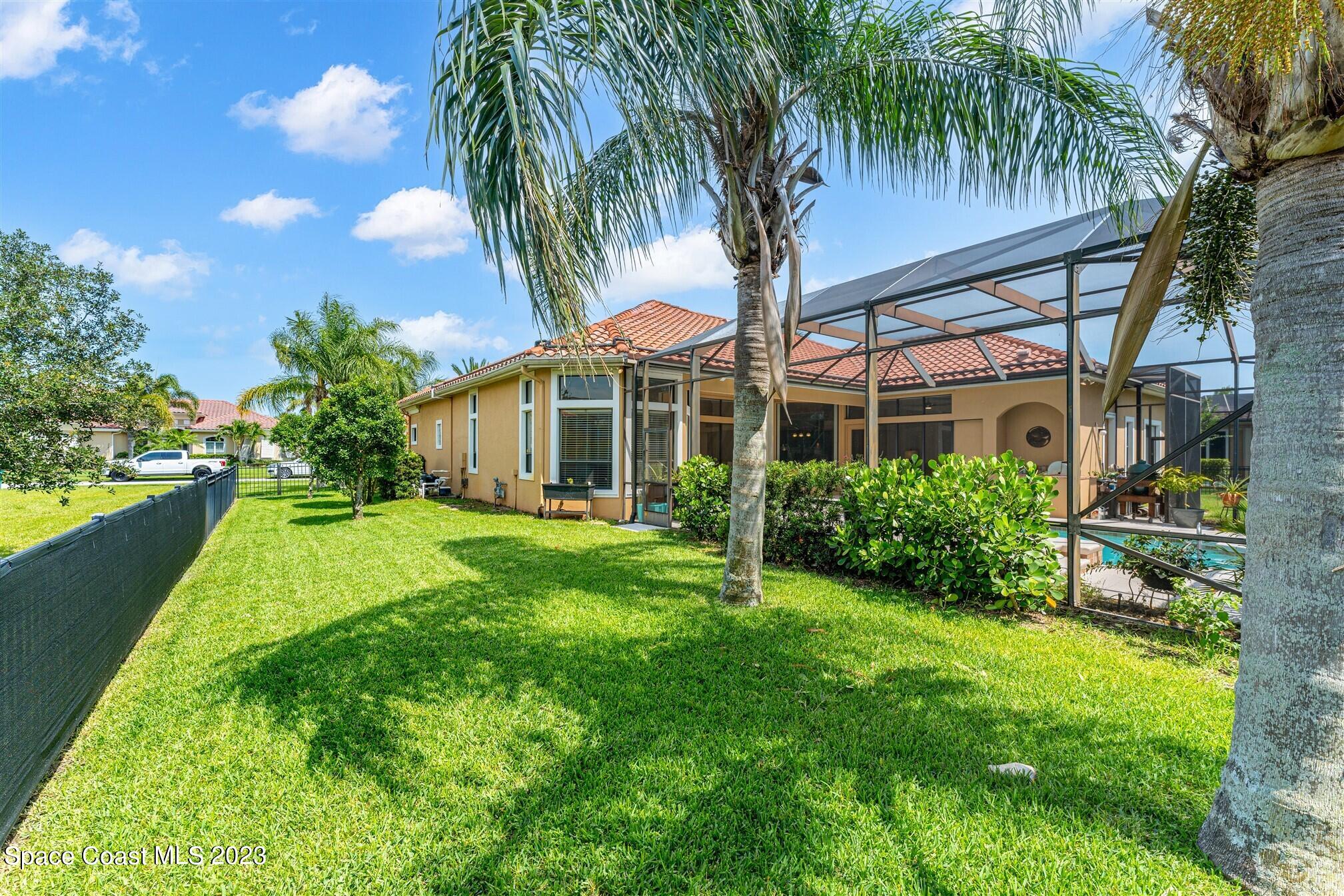 3550 Thurloe Drive Rockledge, FL 32955 - Photo 38 of 44 a view of a house with a yard and palm trees