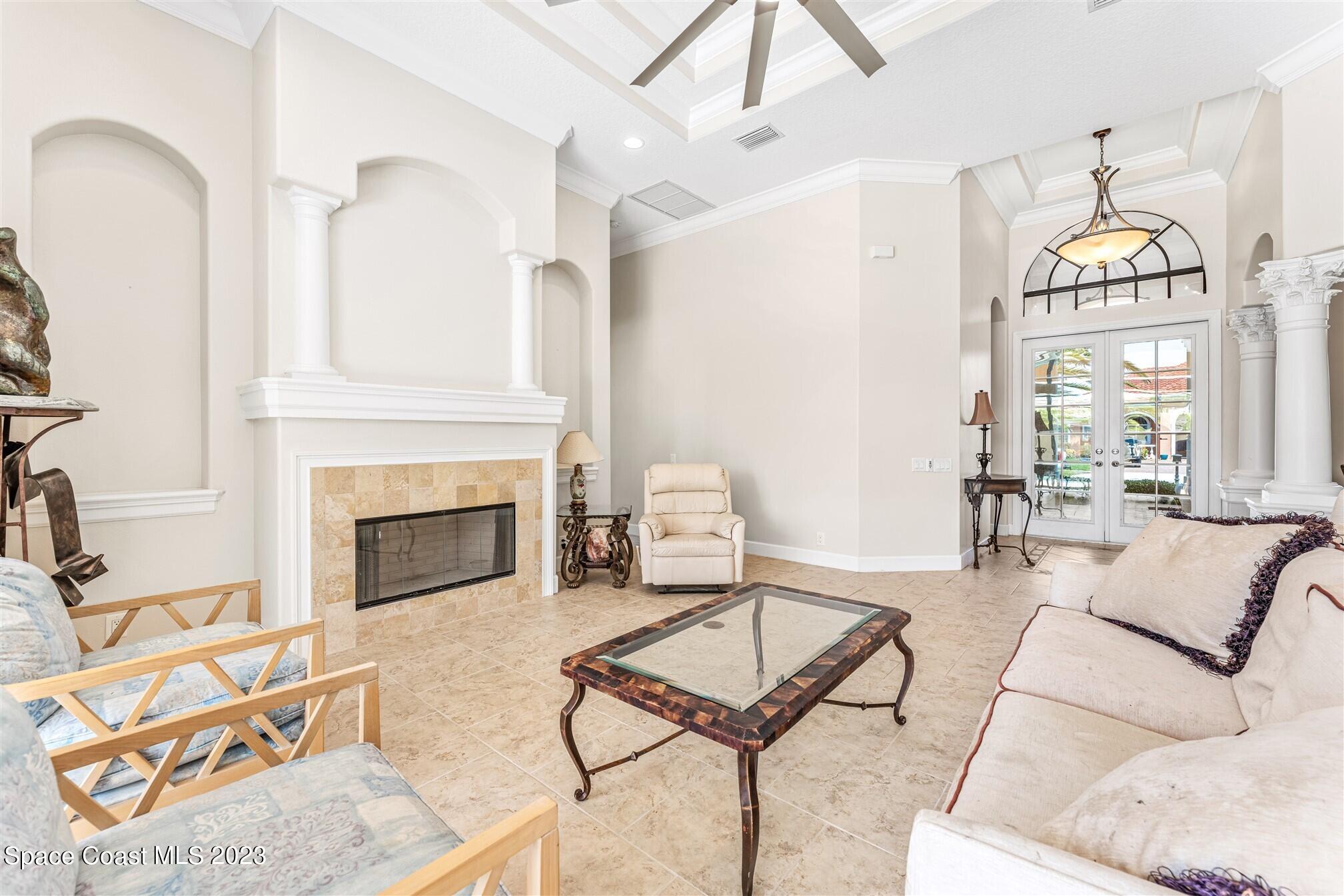 3550 Thurloe Drive Rockledge, FL 32955 - Photo 7 of 44 a living room with furniture a fireplace and a chandelier