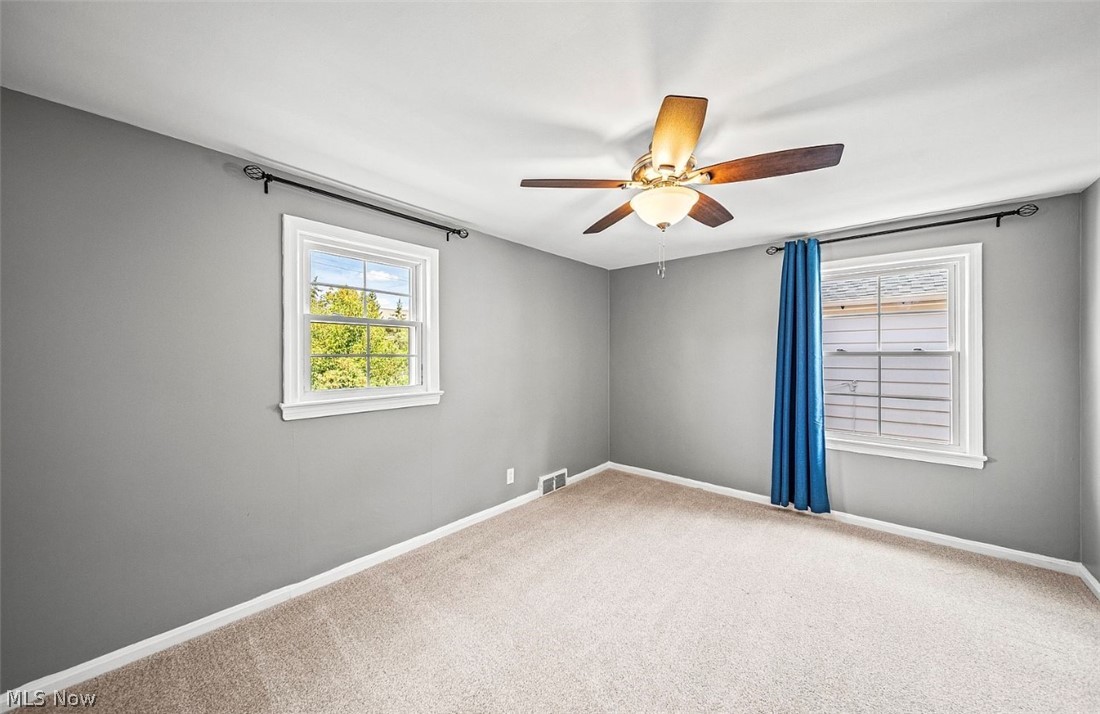4069 Bushnell Road Cleveland, OH 44121 - Photo 20 of 39 Empty room with light carpet and a ceiling fan