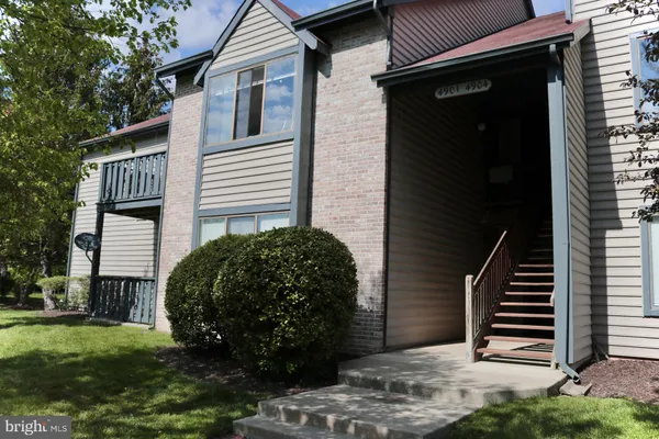 a view of a front of a house with a yard