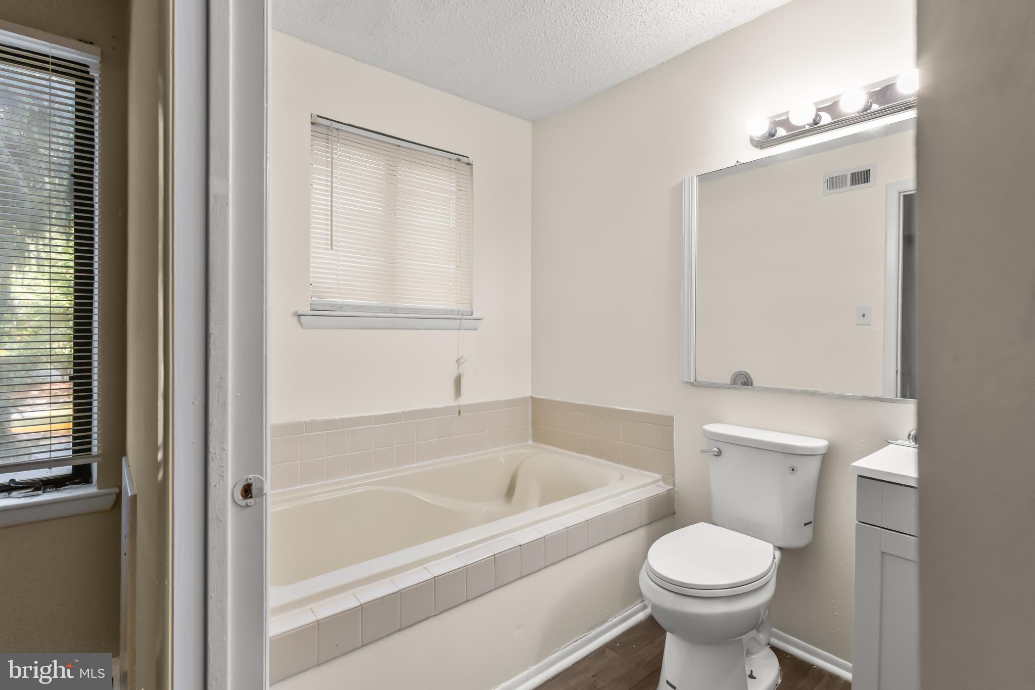 4901A Dunbarton Road Mount Laurel, NJ 08054 - Photo 11 of 12 a bathroom with a sink and bathtub with toilet