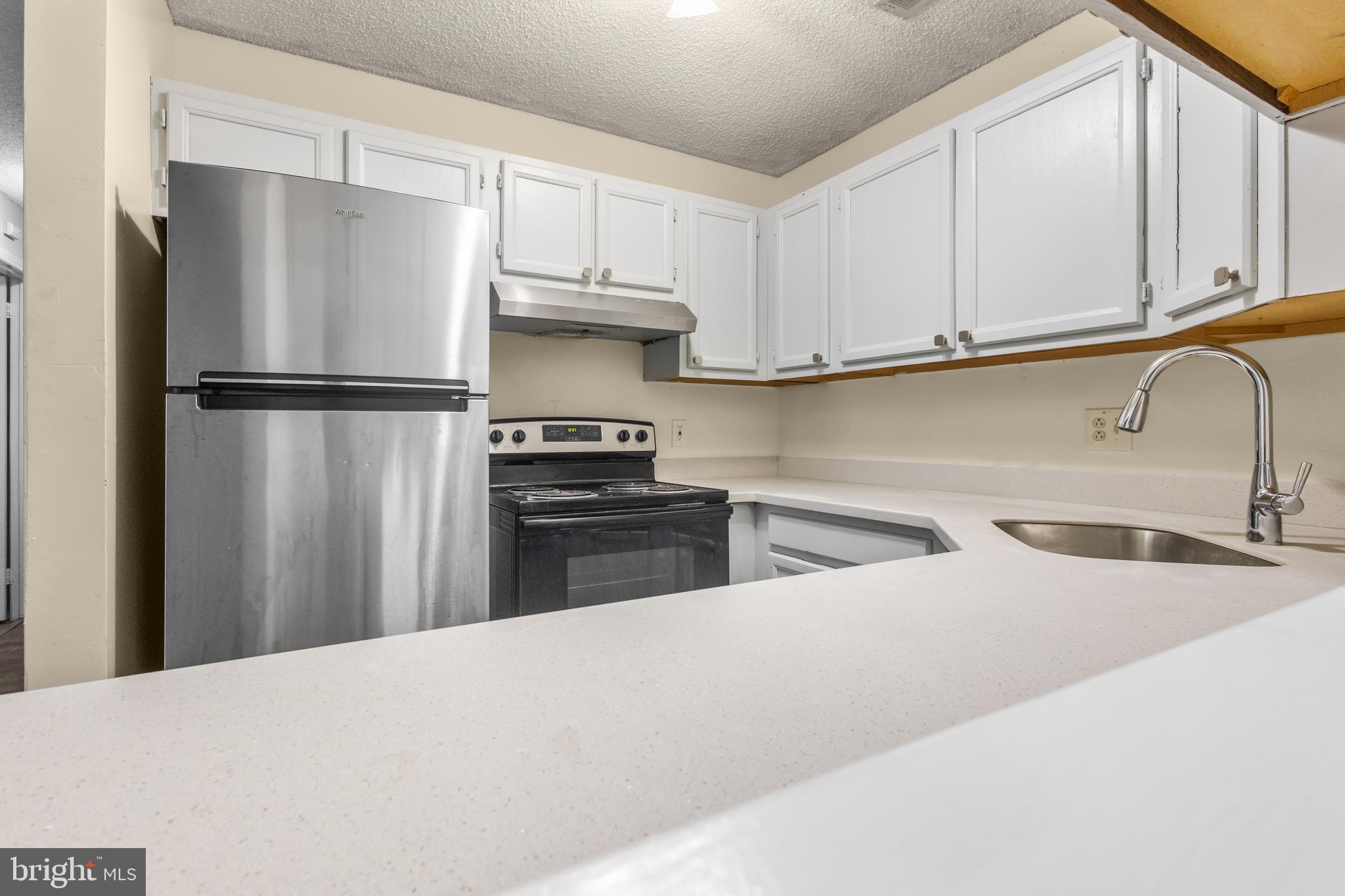 4901A Dunbarton Road Mount Laurel, NJ 08054 - Photo 7 of 12 a kitchen with stainless steel appliances a refrigerator sink and cabinets