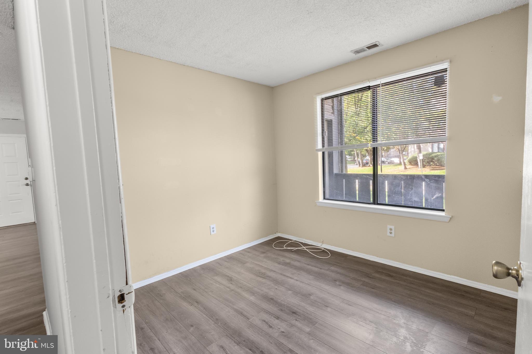 4901A Dunbarton Road Mount Laurel, NJ 08054 - Photo 9 of 12 a view of an empty room with wooden floor and a window