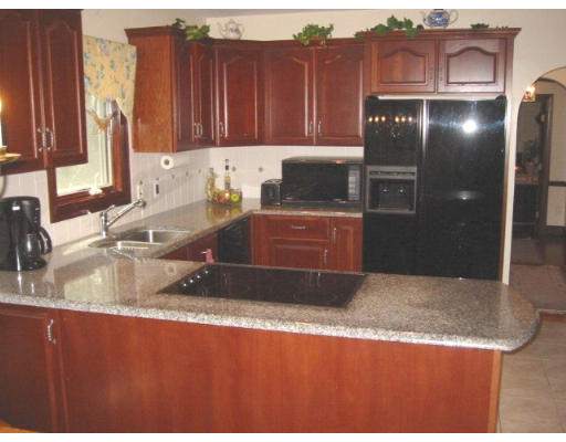 38 Adams Road Boxford, MA 01921 - Photo 13 of 23 a kitchen with granite countertop a refrigerator and a sink
