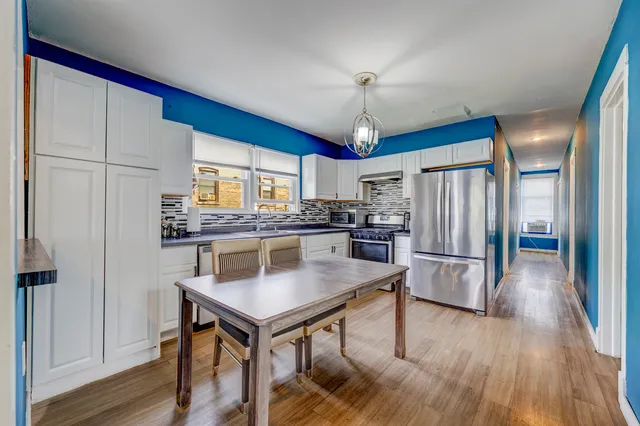 a kitchen with stainless steel appliances a stove a refrigerator and a refrigerator