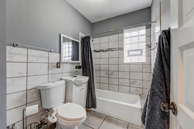 a bathroom with a toilet a sink and bathtub