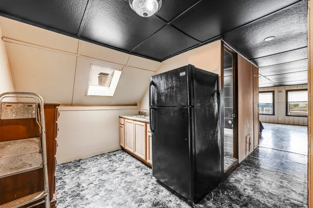 a refrigerator freezer sitting inside of a kitchen