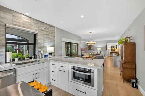 a kitchen with stainless steel appliances granite countertop a stove refrigerator and cabinets