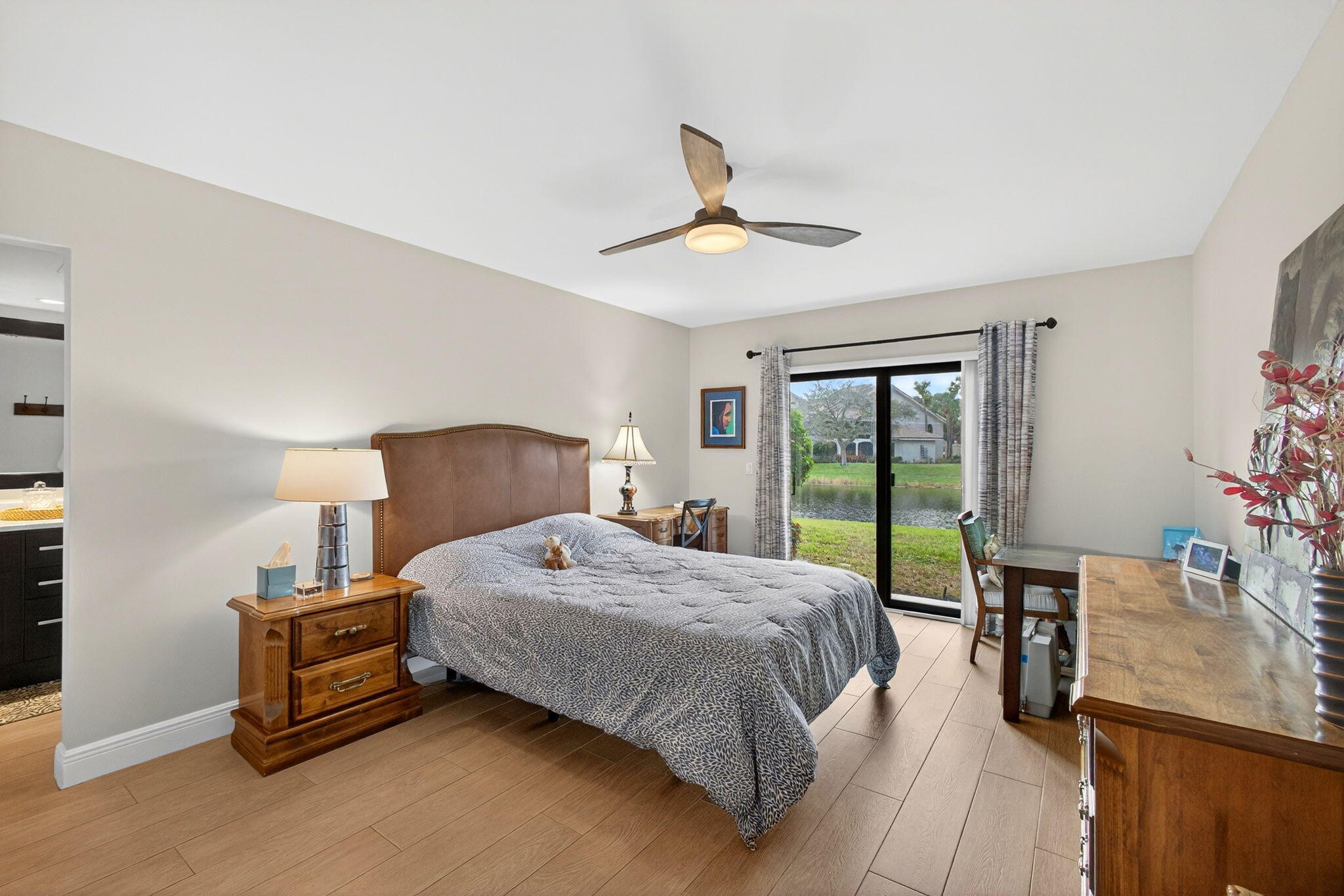 16671 Traders Crossing North, Unit 122 Jupiter, FL 33477 - Photo 20 of 34 a bedroom with a bed dresser and a window