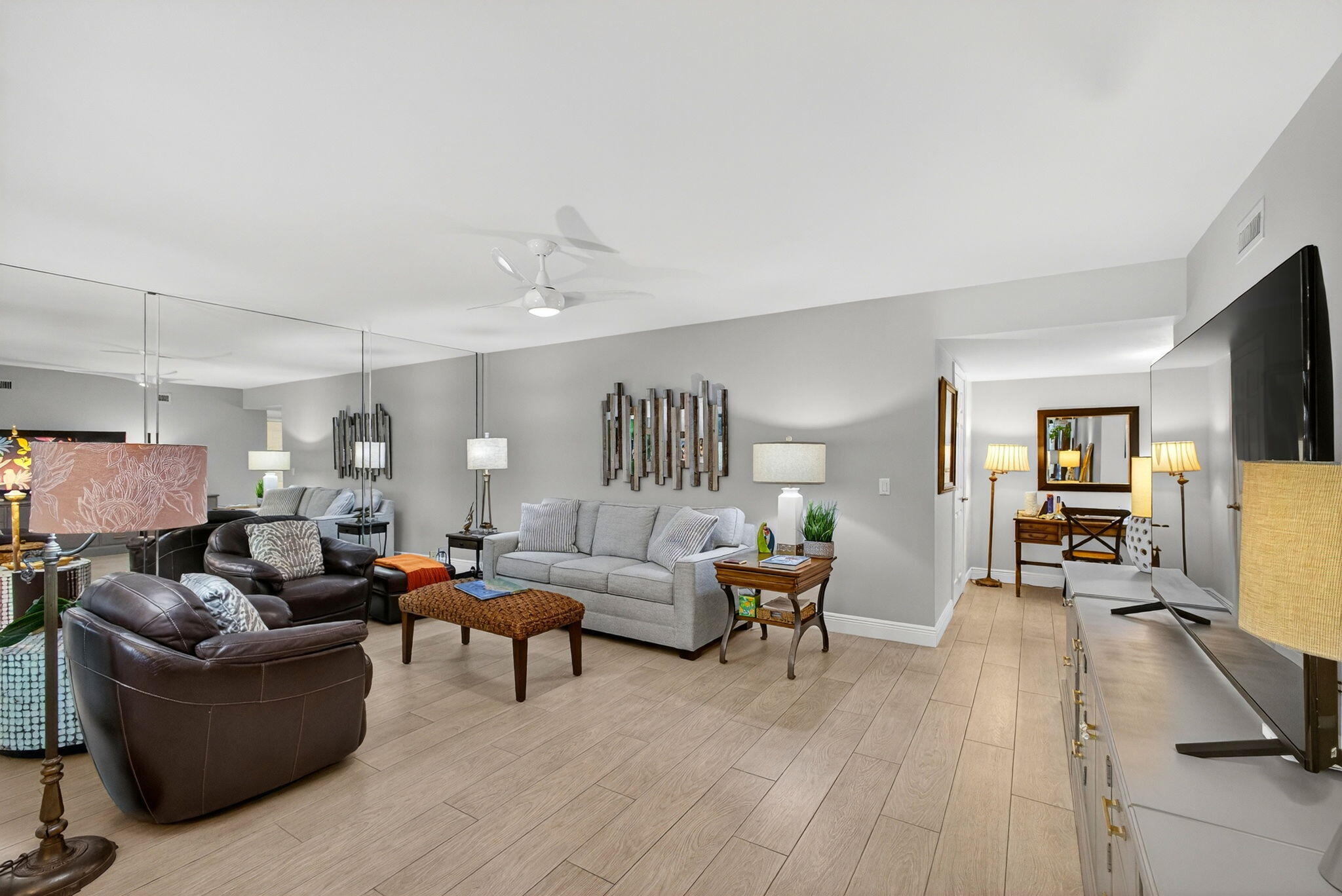 16671 Traders Crossing North, Unit 122 Jupiter, FL 33477 - Photo 3 of 34 a living room with furniture and a flat screen tv