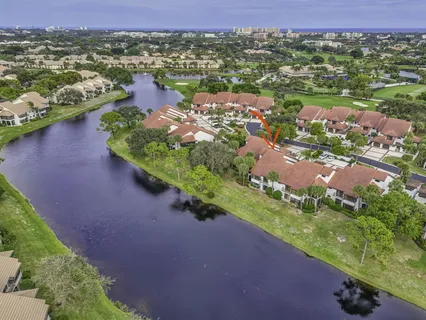 an aerial view of a city with lots of residential buildings ocean and mountain view in back