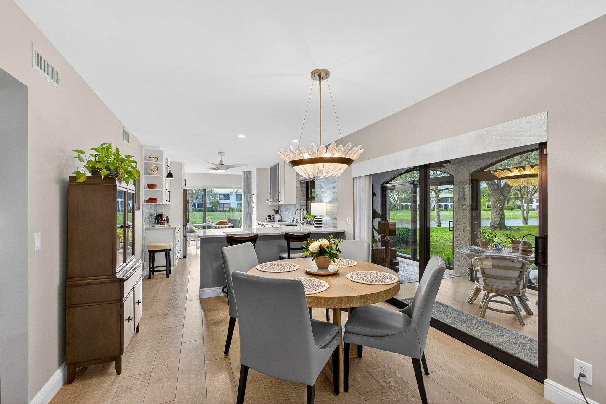 16671 Traders Crossing North, Unit 122 Jupiter, FL 33477 - Photo 7 of 34 a dining room with furniture window and wooden floor