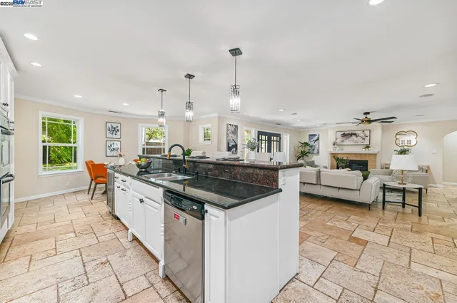 a open kitchen with stainless steel appliances granite countertop a sink and a stove