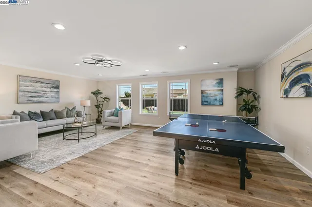 a living room with furniture a dining table and with potted plants