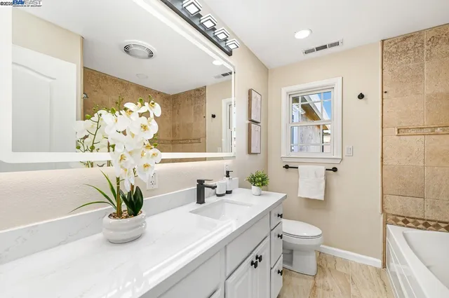 a bedroom with a large bed and a window