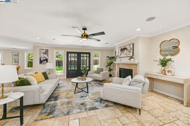a living room with fireplace furniture and a rug