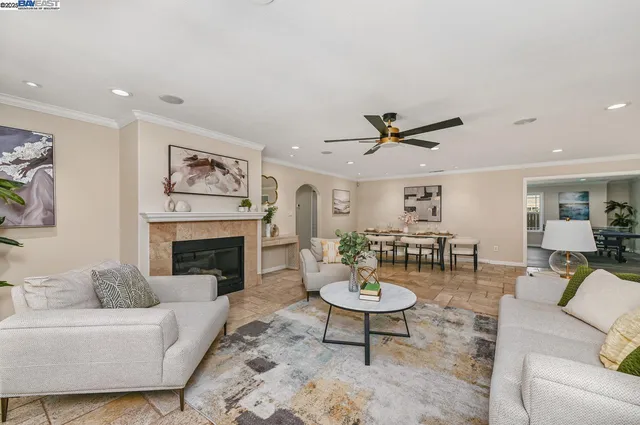 a living room with furniture a fireplace and a window