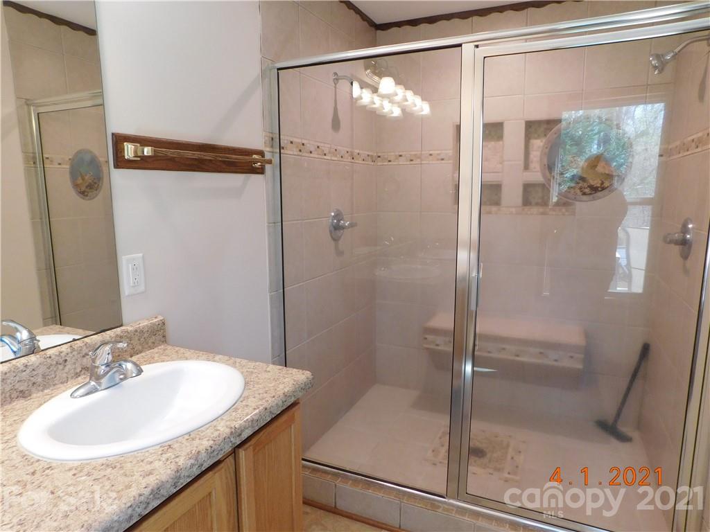 5612 Stack Road Monroe, NC 28112 - Photo 10 of 14 a bathroom with a granite countertop shower sink and mirror