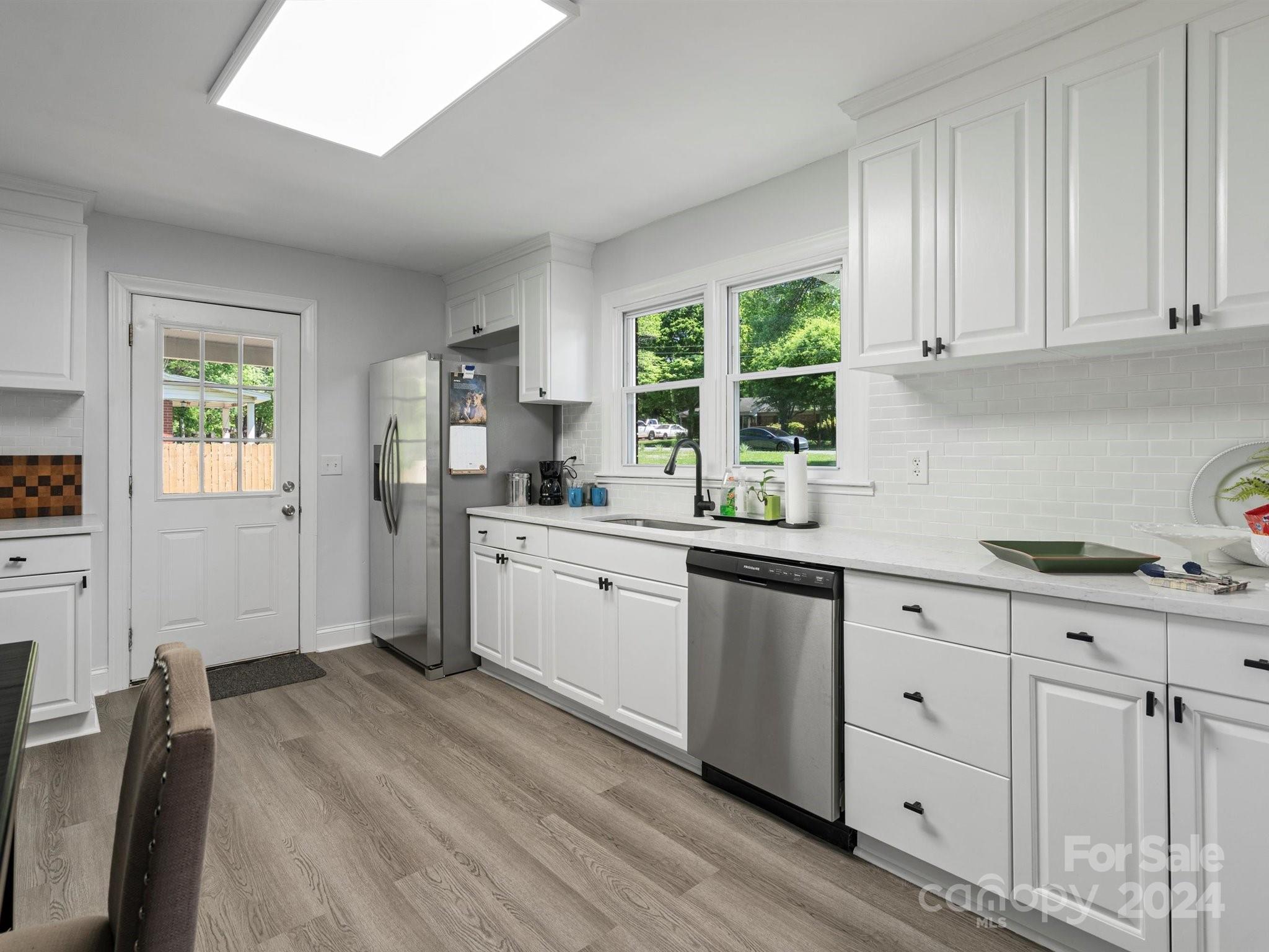 640 Summerow Road Stanley, NC 28164 - Photo 18 of 38 a kitchen with granite countertop white cabinets and white appliances