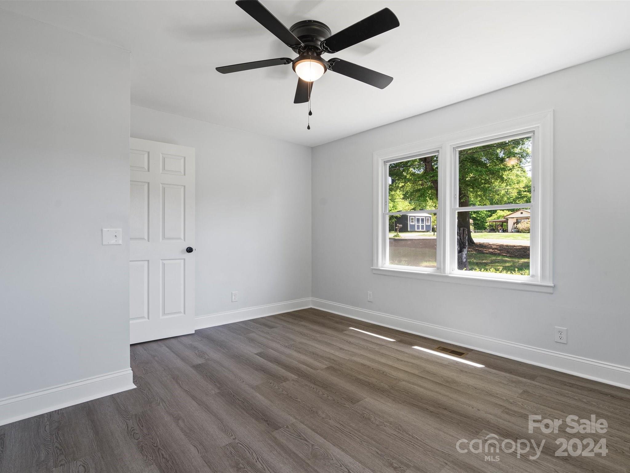 640 Summerow Road Stanley, NC 28164 - Photo 25 of 38 a view of empty room with wooden floor and fan