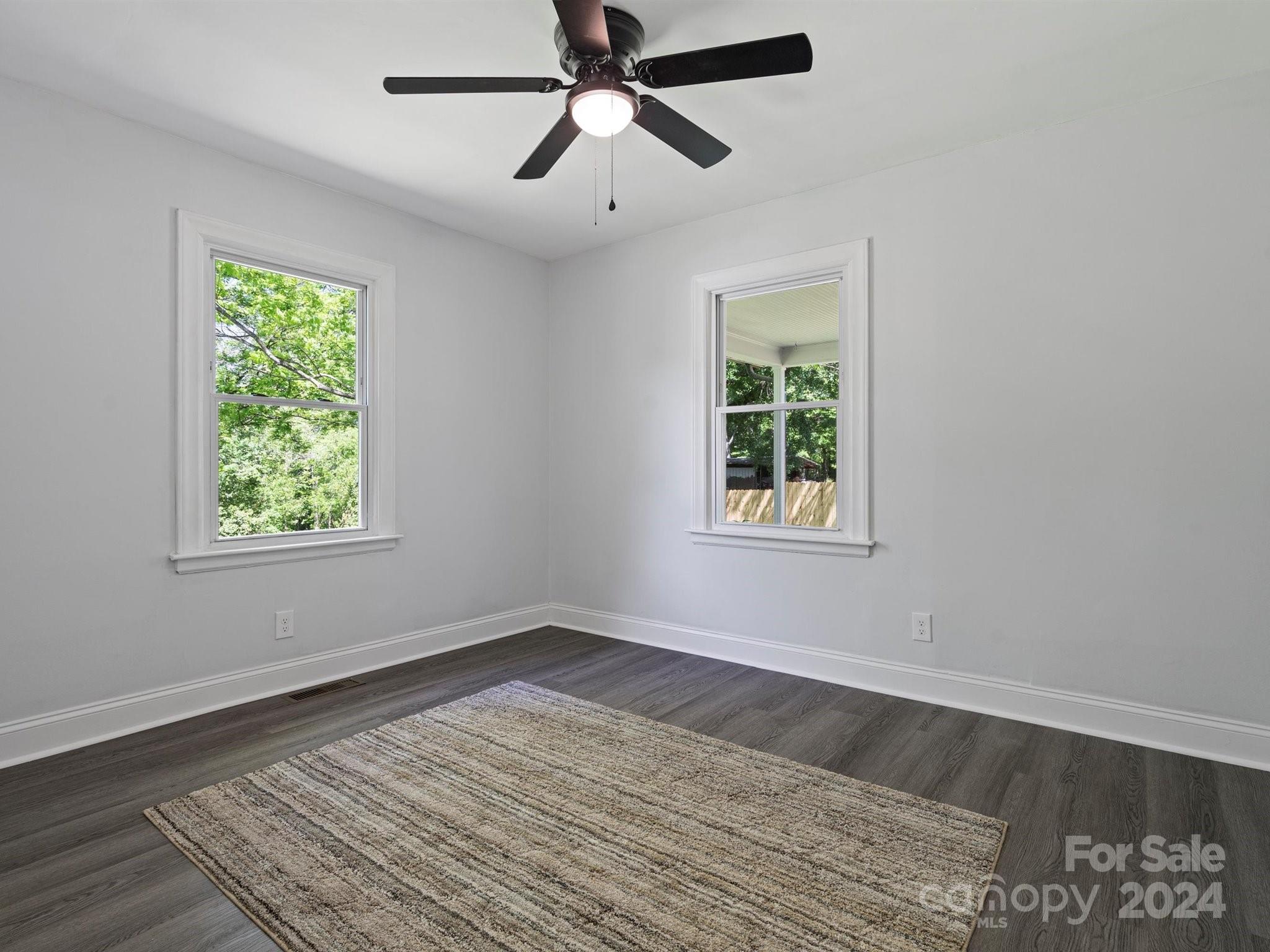 640 Summerow Road Stanley, NC 28164 - Photo 32 of 38 a view of an empty room with wooden floor and a window