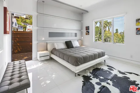 a bedroom with a bed and a window