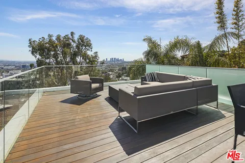 a outdoor sitting area with furniture and a wooden floor