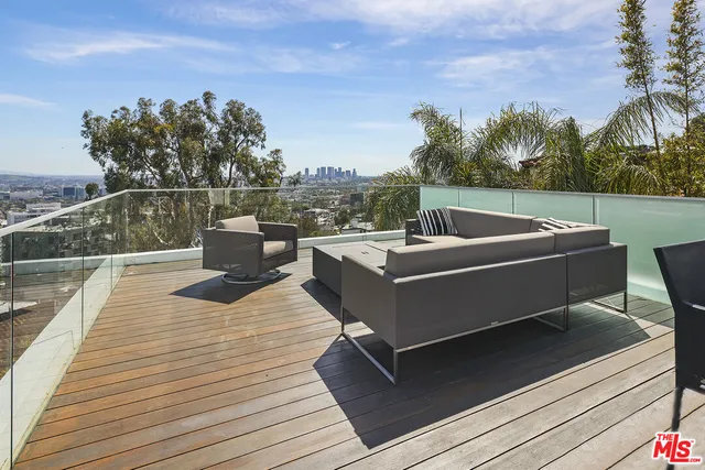 a outdoor sitting area with furniture and a wooden floor