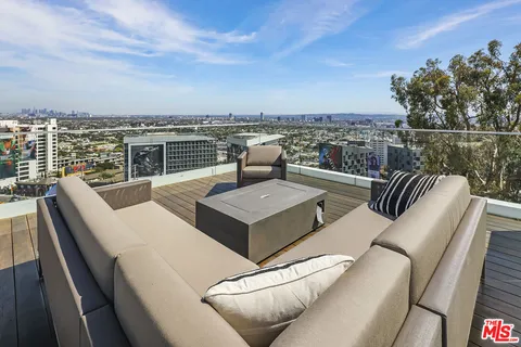 a view of a terrace with couches and city view