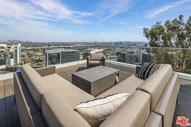 a view of a terrace with couches and city view