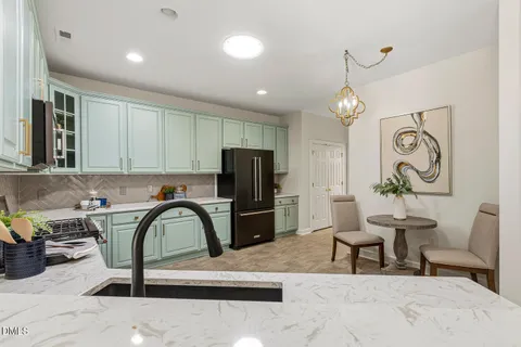 a kitchen with a sink stove and microwave