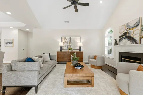 a living room with furniture a fireplace and a large window