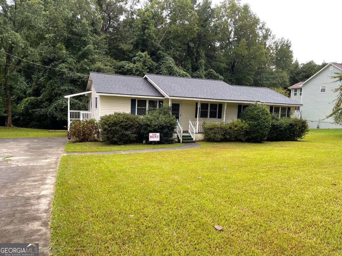 1031 Rock Springs Road Lawrenceville, GA 30043 - Photo 1 of 12 a front view of house with yard and swimming pool