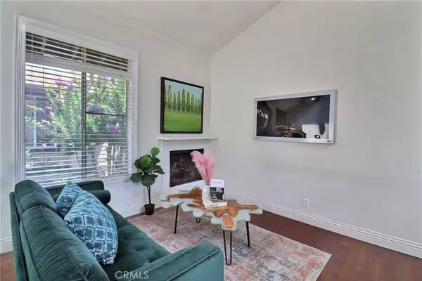 a living room with furniture a fireplace and a flat screen tv