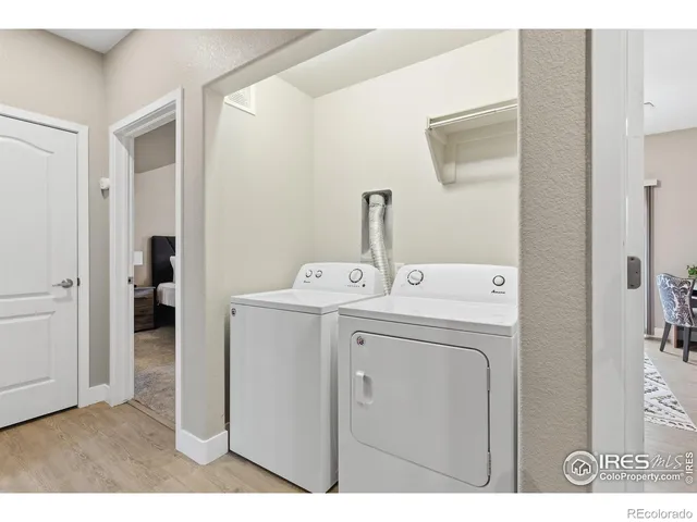 a view of a room with stairs and a refrigerator