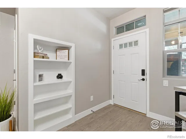 a view of an entryway with wooden floor