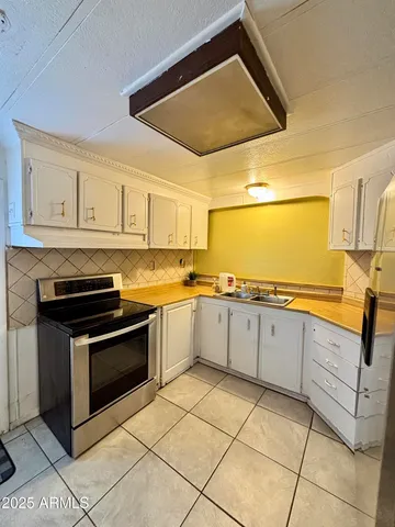 a kitchen with cabinets and appliances