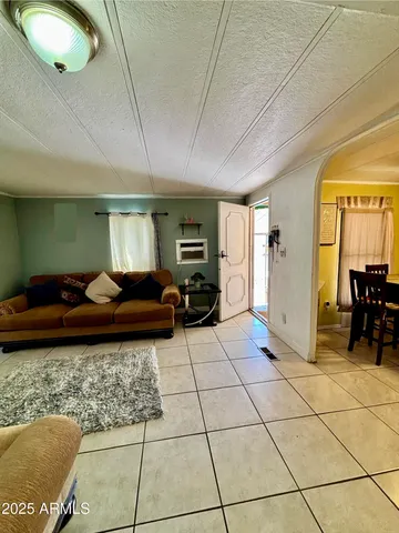a living room with furniture and a dining table