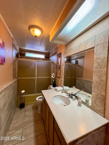 a bathroom with a sink mirror and shower