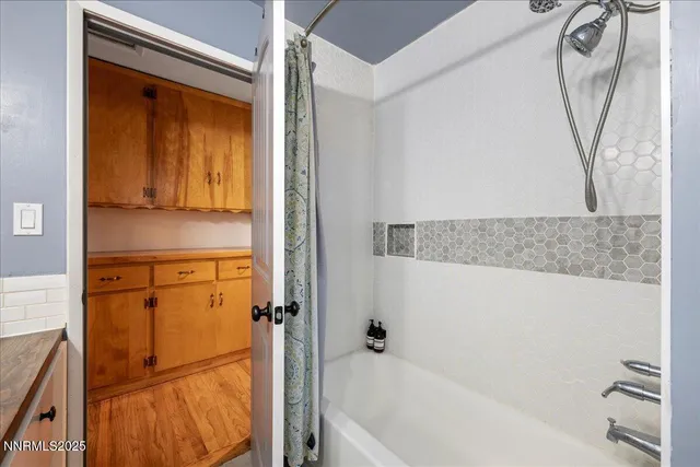 a bathroom with a tub and a shower