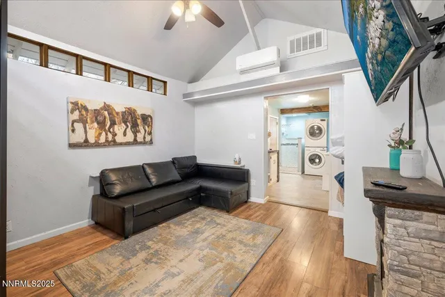a living room with furniture and a painting on the wall