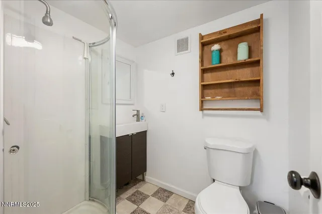 a bathroom with a toilet sink and shower
