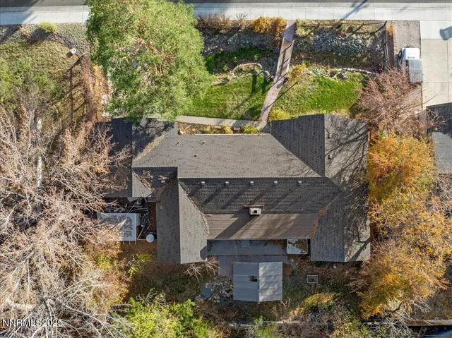 an aerial view of a house with a yard