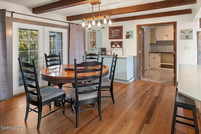 a dining room with furniture a chandelier and wooden floor