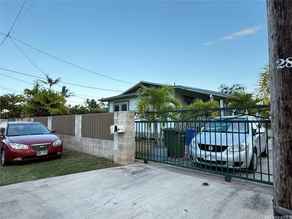 a view of a house with a small yard and furniture